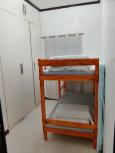 a small wooden bunk bed in a room at Zoldyck 2 Home in Pahanocoy