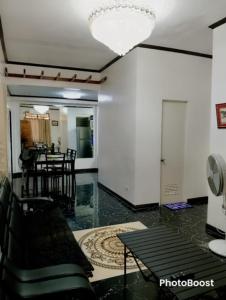 a living room with black chairs and a table at Zoldyck 2 Home in Pahanocoy