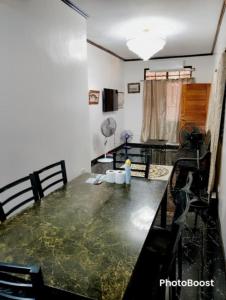a dining room with a table with water on it at Zoldyck 2 Home in Pahanocoy