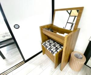 a bathroom with a mirror next to a door at comodo inn HANAZONO in Aomori