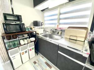 a kitchen with a sink and a counter top at comodo inn HANAZONO in Aomori