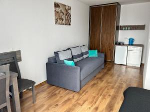 a living room with a couch and a table at Villa Over Lake in Mielno