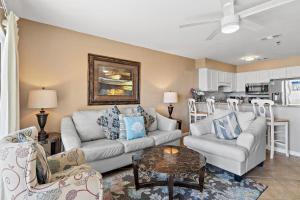 a living room with two couches and a table at Windancer 110 in Destin