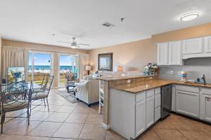 a kitchen and dining room with a view of the ocean at Windancer 110 in Destin +27 photos