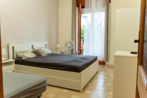 a bedroom with a bed and a large window at Casa Solemare Strongoli in Marina di Strongoli