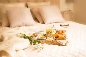 a tray of food on top of a bed at Proxima Quarters in Rawalpindi