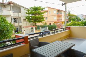 a balcony with a table and chairs and buildings at Casa Solemare Strongoli in Marina di Strongoli