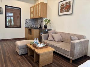 a living room with a couch and a coffee table at An Thuong House - Hoan Kiem, Hanoi Center in Hanoi