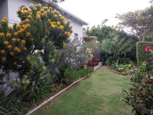 a garden with yellow and orange flowers on a building at B's Place in Port Elizabeth