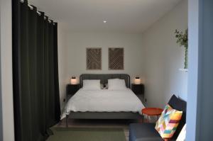 a bedroom with a bed and a green curtain at La Villa Séquoia in Les Bordes-Aumont +30 photos
