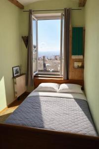 a bed in a room with a large window at amazing view appartment in Lyon