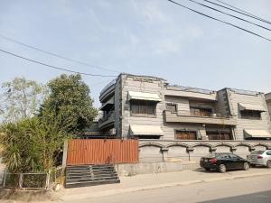 a building with a car parked in front of it at Proxima Quarters in Rawalpindi