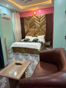 a bedroom with a bed and a table and a chair at Unique CityLife Hotel in Etoi +14 photos