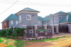 a row of houses with green roofs at Unique CityLife Hotel in Etoi