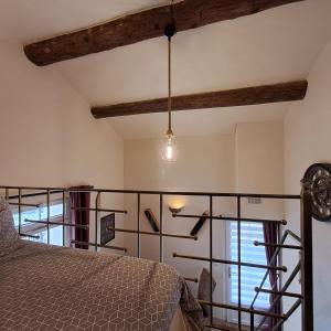 a bedroom with a bed and a glass railing at Le Mas des Deux Tilleuls in Sablet