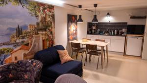 a living room with a blue couch and a table at Stee in Stad in Groningen