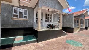 a rendering of a house with a balcony at Dolphin AIR B&B in Arusha
