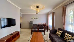 a living room with a couch and a table at Dolphin AIR B&B in Arusha