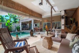 a living room with a couch and a pool at Jellyfish2 2BR for Groups, 5 Min to Thomas Beach in Uluwatu