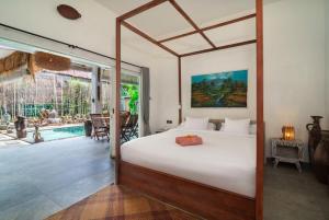 a bedroom with a bed and a swimming pool at Jellyfish2 2BR for Groups, 5 Min to Thomas Beach in Uluwatu