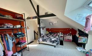 a bedroom with a bed and a large mirror at Tardif in Vitré