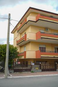 a large building with a fence in front of it at Casa Solemare Strongoli in Marina di Strongoli