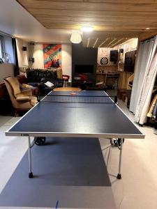 a ping pong table in the middle of a living room at Moulin in Vitré +12 photos