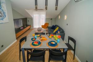 a dining room with a table with food on it at Seaview Villa Rajmond in Podstrana