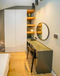 a bedroom with a desk and a mirror at Seaview Villa Rajmond in Podstrana