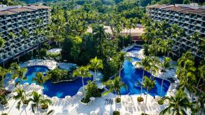 an aerial view of a resort with pools and palm trees at Barceló Puerto Vallarta - All Inclusive in Puerto Vallarta