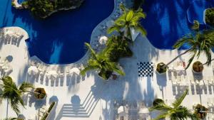 an overhead view of a pool with palm trees at Barceló Puerto Vallarta - All Inclusive in Puerto Vallarta