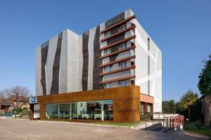 a tall building with glass windows in front of it at Best Western Hotel Continental in Udine