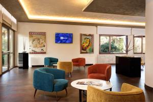 a waiting room with colorful chairs and tables at Best Western Hotel Continental in Udine