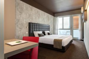 a hotel room with a bed and a table and a desk at Best Western Hotel Continental in Udine +46 photos