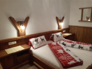 a bed in a room with two lights on the wall at Landsitz im Reitle in Längenfeld