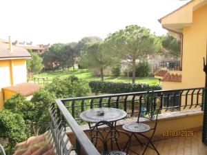 a balcony with a table and a view of a yard at Anagnina Apartment Capistrano in Rome