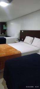 a bedroom with two beds with white sheets at Ocean Flat Tambaú in João Pessoa