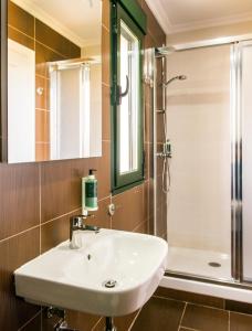 a bathroom with a sink and a shower at Pensión Casa Rego Sarria in Sarria +26 photos
