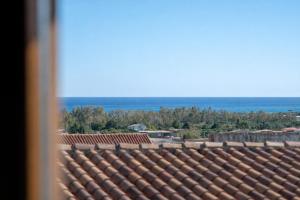 a view of the roof of a building with the ocean at Casa Ombrina in Orosei