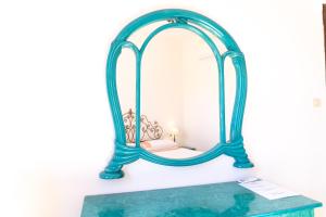 a blue mirror sitting on top of a table at Casa Ombrina in Orosei