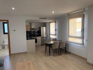 a kitchen and dining room with a table and chairs at Hostal Mallorquines in Riudarenes +10 photos