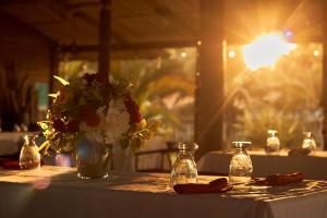 a table with a vase of flowers on it at Hotel Palmazul - Viña del Mar in Omoa +206 photos