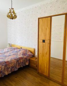 a bedroom with a bed and a wooden closet at Residenz Emilia in Mariánské Lázně
