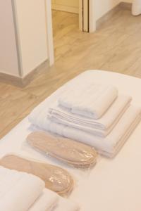 a pile of white towels sitting on a table at B&B Domus Vettii in Pompei +87 photos