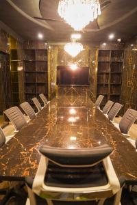 a conference room with a long table and chairs at Proxima Quarters in Rawalpindi