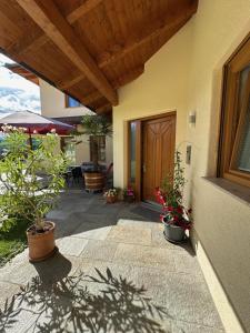 a porch of a house with potted plants on it at Haus Leblhuber in Windischgarsten