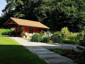 a small house in the middle of a garden at Haus Leblhuber in Windischgarsten