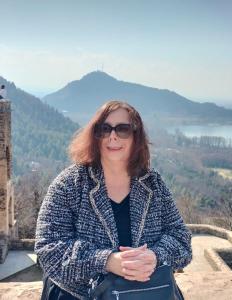 a woman standing on top of a tower with a mountain at Sea Green Guest House in Srinagar