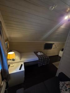a small room with a bed and a tv at Stryn Kaffebar & Vertshus in Stryn