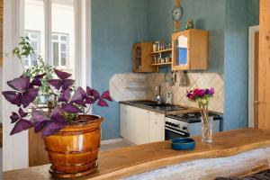 a kitchen with a wooden table with flowers on it at amazing view appartment in Lyon